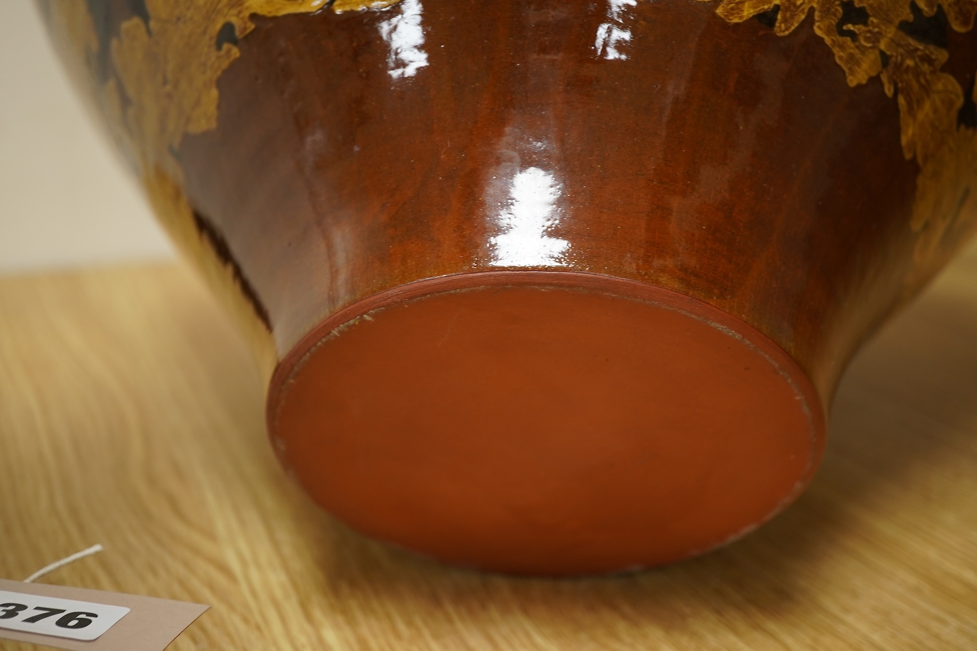 A large terracotta foliaiate decorated vase, 38cm high